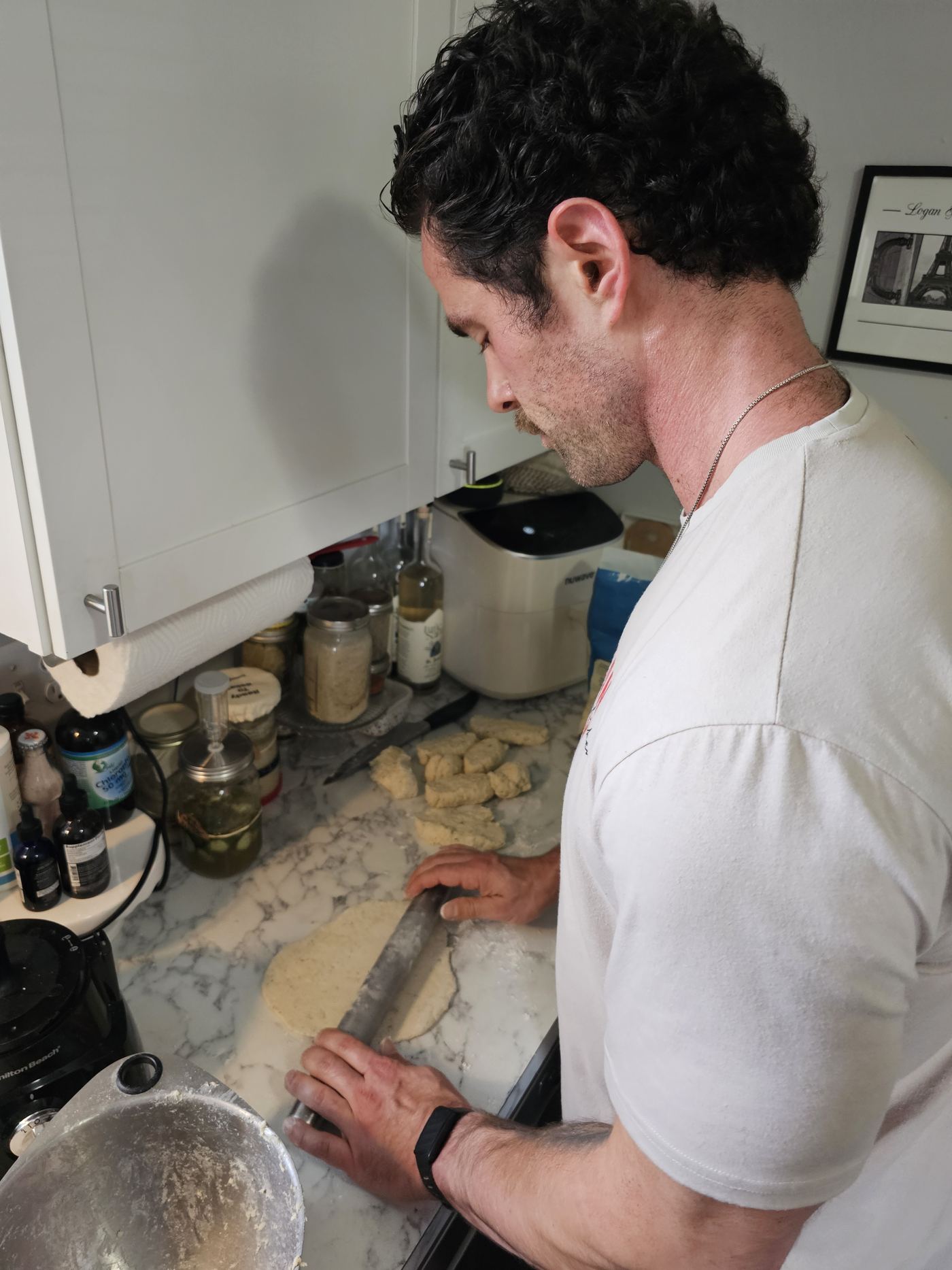Logan rolling out homemade dough in his kitchen